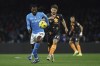 Napoli's Andre-Frank Zambo Anguissa, left, and Torino's Karol Linetty fight for the ball during an Italian Serie A soccer match between Napoli and Torino at the Diego Armando Maradona stadium, in Naples, Italy, Friday, March 8, 2024. (Alessandro Garofalo/LaPresse via AP)