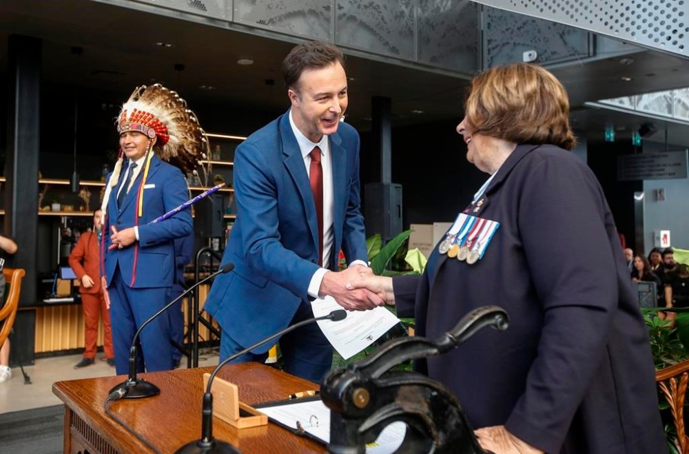 Manitoba Premier Wab Kinew looks on as Adrien Sala, minister of finance, is sworn-in by Lt. Gov. Anita Neville in Winnipeg on Wednesday, Oct. 18, 2023. Manitoba's NDP government has launched advertisements touting income tax cuts that were put forward and passed by the former Progressive Conservative government. THE CANADIAN PRESS/John Woods