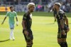 Los Angeles FC midfielder Timothy Tillman,left, and forward Denis Bouanga (99) celebrate a goal during the first half of an MLS soccer match against the Seattle Sounders, Saturday, Feb. 24, 2024, in Los Angeles. (AP Photo/Eric Thayer)