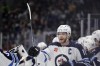 Winnipeg Jets center Adam Lowry (17) celebrates his goal against the Seattle Kraken during the third period of an NHL hockey game, Friday, March 8, 2024, in Seattle. The Jets won 3-0. (AP Photo/John Froschauer)