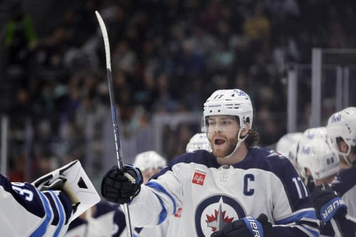 Winnipeg Jets center Adam Lowry (17) celebrates his goal against the Seattle Kraken during the third period of an NHL hockey game, Friday, March 8, 2024, in Seattle. The Jets won 3-0. (AP Photo/John Froschauer)