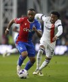 Crystal Palace's Jordan Ayew, left and Luton Town's Gabriel Osho vie for the ball, during the English Premier League soccer match between Crystal Palace and Luton Town, at Selhurst Park, in London, Saturday March 9, 2024. (Bradley Collyer/PA via AP)