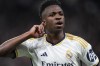 FILE - Real Madrid's Vinicius Junior celebrates after scoring his side's opening goal during the Champions League round of 16 second leg soccer match between Real Madrid and RB Leipzig at the Santiago Bernabeu stadium in Madrid, Spain, on March 6, 2024. Real Madrid coach Carlo Ancelotti says that he has “never seen a player who has been so poorly treated” as his forward Vinícius Júnior. Ancelotti said on Saturday, March 9, 2024 a day before Madrid plays Celta Vigo. (AP Photo/Manu Fernandez, File)