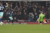 Brentford's Yoane Wissa, second from left, scores his side's first goal past Arsenal's goalkeeper Aaron Ramsdale during the English Premier League soccer match between Arsenal and Brentford at the Emirates Stadium in London, England, Saturday, March 9, 2024. (AP Photo/Frank Augstein)