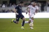 Vancouver Whitecaps forward Brian White, left, moves the ball upfield past San Jose Earthquakes defender Rodrigues during the second half of an MLS soccer match in San Jose, Calif., Saturday, March 9, 2024. Vancouver won 2-0. (AP Photo/Tony Avelar)