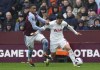 Aston Villa's Ezri Konsa, left, and Tottenham Hotspur's Son Heung-Min battle for the ball during the English Premier League soccer match at Villa Park, Birmingham, England, Sunday March 10, 2024. (Nick Potts/PA via AP)