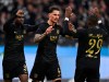 Frankfurt's Robin Koch, center, celebrates scoring with teammates Eric Junior Dina Ebimbe, left, and Niels Nkounkou during the Bundesliga soccer match between Eintracht Frankfurt and TSG 1899 Hoffenheim at Deutsche Bank Park in Frankfurt, Germany, Sunday March 10, 2024. (Arne Dedert/dpa via AP)