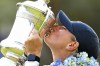 In this photo released by Xinhua News Agency, Bailey Tardy of the United States kisses the trophy after winning the Blue Bay LPGA golf tournament in Lingshui, southern China's Hainan province on Sunday, March 10, 2024. Bailey Tardy picked up her first victory on the LPGA Tour, shooting a 7-under 65 in the final round of the Blue Bay tournament on China's southern island of Hainan to win by four strokes ahead of Sarah Schmelzel. (Yang Guanyu/Xinhua via AP)