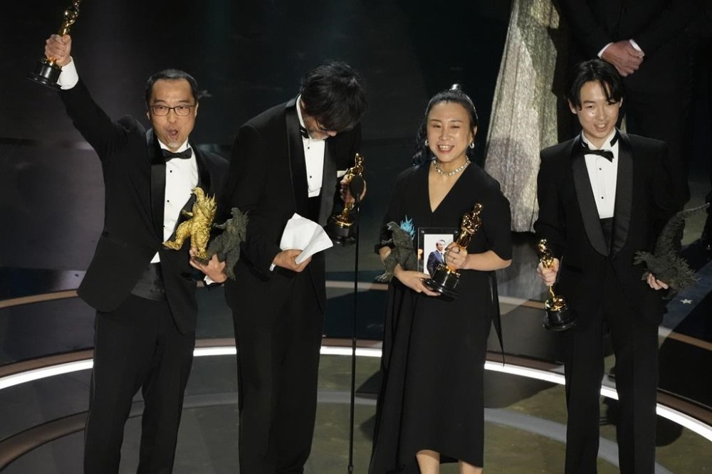 Masaki Takahashi, from left, Takashi Yamazaki, Kiyoko Shibuya, and Tatsuji Nojima accept the award for best visual effects for