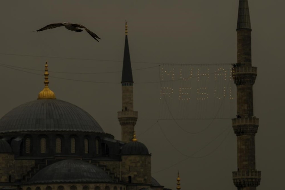 Mahya masters, top right, work in the installation of a lights message at the top of one of the minarets of the Ottoman-era Sultanahmet mosque, or Blue mosque, ahead of the Muslim holy month of Ramadan, in Istanbul, Turkey, Tuesday, March 5, 2024. Mahya is the unique Turkish tradition of stringing religious messages and designs between minarets. (AP Photo/Emrah Gurel)