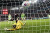 Leverkusen's Nathan Tella, centre, scores the opening goal past Wolfsburg's goalkeeper Koen Casteels during the German Bundesliga soccer match between Bayer Leverkusen and VfL Wolfsburg at the BayArena in Leverkusen, Germany, Sunday, March 10, 2024. (AP Photo/Martin Meissner)