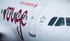 Air Canada says a mother and her newborn child are believed to be in good health after she went into premature labour and gave birth mid-flight. An Air Canada Rouge aircraft prepares for a flight at Vancouver International Airport in Richmond, B.C., Monday, April 28, 2014. THE CANADIAN PRESS/Darryl Dyck