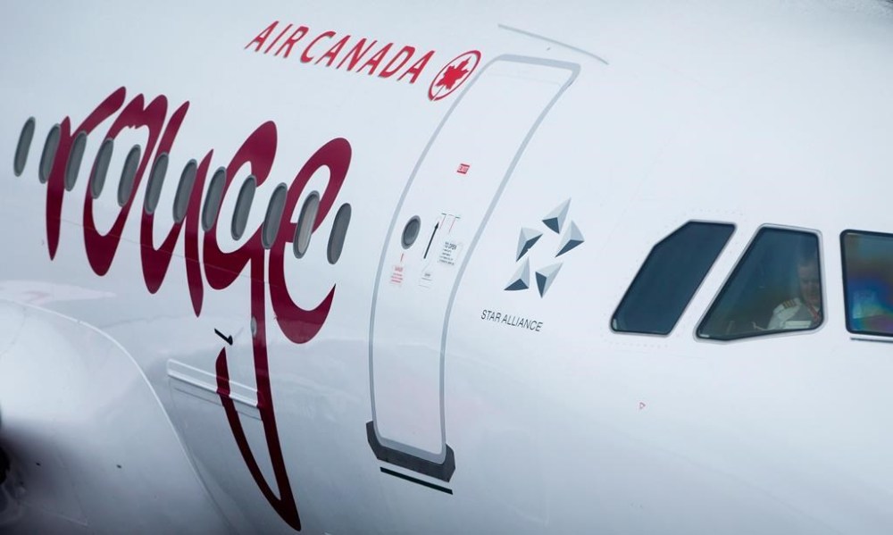 Air Canada says a mother and her newborn child are believed to be in good health after she went into premature labour and gave birth mid-flight. An Air Canada Rouge aircraft prepares for a flight at Vancouver International Airport in Richmond, B.C., Monday, April 28, 2014. THE CANADIAN PRESS/Darryl Dyck