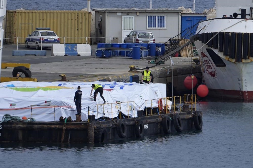 Port staffers prepare the aid on a platform near to the docked ship belonging to the Open Arms aid group, as it prepares to ferry some 200 tonnes of rice and flour directly to Gaza, at the port in Larnaca, Cyprus, on Sunday, March 10, 2024. The European Commission president said Friday the Open Arms ship will make a pilot voyage as international donors launched a sea corridor to supply the besieged territory that is facing widespread hunger after five months of war. (AP Photo/Petros Karadjias)