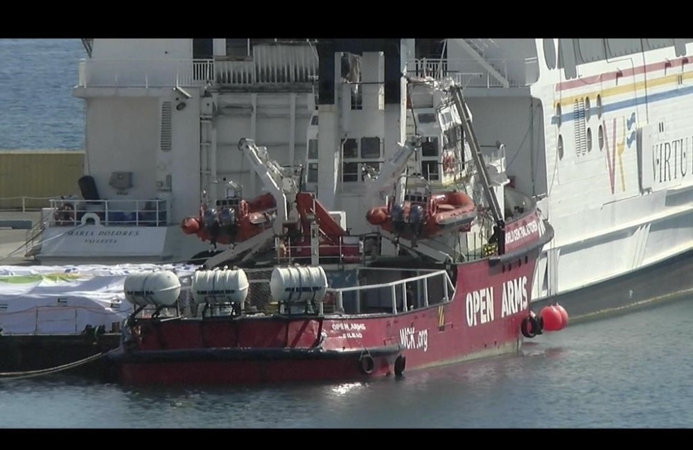 This image made from video shows a ship belonging to Spanish aid group Open Arms, background, and an aid barge docked at Larnaca port in Cyprus, Monday, March 11, 2024. World Food Kitchen, the charity founded by celebrity chef Jose Andres, posted on the X social media platform that the Open Arms ship loaded with some 200 tons of food set sail Tuesday. (AP Photo)