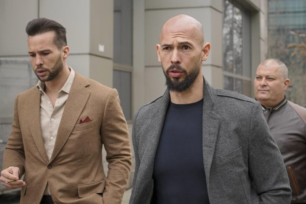 FILE - Andrew Tate, right, and his brother Tristan leave the tribunal in Bucharest, Romania, Thursday, Feb. 29, 2024. Online influencer Andrew Tate was detained in Romania and handed an arrest warrant issued by British authorities, his spokesperson said Tuesday, March 12. Tate, 37, and his brother Tristan Tate were detained Monday evening on allegations of sexual aggression in a U.K. case dating back to 2012-2015, spokesperson Mateea Petrescu said. (AP Photo/Vadim Ghirda, File)