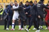 Verona's Thomas Henry, in white, leaves the pitch after the Serie A soccer match between U.S. Lecce and Hellas Verona FC at Via del Mare Stadium, Lecce, Italy, Sunday March 10, 2024. Lecce coach Roberto D’Aversa, foreground center, head butted Hellas Verona striker Thomas Henry following a heated matchup between two teams just above the relegation zone in Serie A on Sunday. (Giovanni Evangelista/LaPresse via AP)