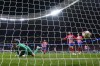 Atletico Madrid's goalkeeper Jan Oblak, left bottom, fails to save the ball as Inter Milan's Federico Dimarco, top left, celebrates after scoring his side's opening goal during the Champions League, round of 16, second leg soccer match between Atletico Madrid and Inter Milan at the Metropolitano stadium in Madrid, Spain, Wednesday, March 13, 2024. (AP Photo/Manu Fernandez)
