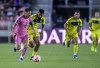 Inter Miami forward Lionel Messi races ahead of Nashville SC midfielder Anibal Godoy during the first half of a CONCACAF Champions Cup soccer match Wednesday, March 13, 2024, in Fort Lauderdale, Fla. (AP Photo/Michael Laughlin)