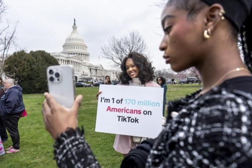 FILE - Devotees of TikTok, Mona Swain, center, and her sister, Rachel Swain, right, both of Atlanta, monitor voting at the Capitol in Washington, as the House passed a bill that would lead to a nationwide ban of the popular video app if its China-based owner doesn't sell, March 13, 2024. If some U.S. lawmakers have their way, the United States and China could end up with something in common: TikTok might not be available in either country. (AP Photo/J. Scott Applewhite, File)