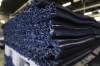 Surface portion of an athletics track is displayed at the Mondo factory, in Alba, northern Italy, Wednesday, March 13, 2024. The athletics track for the upcoming Paris Olympics is being produced by the Mondo company at its factory in northern Italy. The track is made in portions, rolled up and then will be transported to the Stade de France, where it will be installed over the next month. (AP Photo/Luca Bruno)
