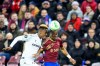 Viktoria Plzen's Sampson Dweh, left, challenges for the ball with Servette's Dereck Kutesa during the Europa Conference League round of 16 first leg soccer match between Servette FC and FC Viktoria Plzen at the Stade de Geneve stadium in Geneva, Switzerland, Thursday, March 7, 2024. (Martial Trezzini/Keystone via AP)