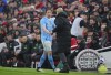 Manchester City's Kevin De Bruyne, left, shakes hands with his coach Pep Guardio after leaving the pitch during the English Premier League soccer match between Liverpool and Manchester City, at Anfield stadium in Liverpool, England, Sunday, March 10, 2024. (AP Photo/Jon Super)