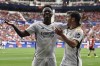 Real Madrid's Brahim Diaz, right, celebrates with teammate Real Madrid's Vinicius Junior after scoring his side's third goal during the Spanish La Liga soccer match between Osasuna and Real Madrid at the El Sadar stadium in Pamplona, Spain, Saturday, March 16, 2023. (AP Photo/Alvaro Barrientos)