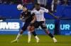 Vancouver Whitecaps forward Brian White, left, and FC Dallas' Patrickson Delgado (6) compete for the ball during the first half of an MLS soccer match, Saturday, March 16, 2024, in Frisco, Texas. (AP Photo/Julio Cortez)