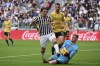 Genoa goalkeeper Josep Martinez saves on Juventus' Fabio Miretti during the Italian Serie A soccer match between Juventus and Genoa at the Allianz Stadium in Turin, Italy, Sunday, March 17, 2024. (Marco Alpozzi/LaPresse via AP)