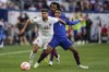 Canada midfielder Jonathan Osorio (21) moves the ball against United States forward Jesús Ferreira (9) during a CONCACAF Gold Cup semifinal soccer match, Sunday, July 9, 2023, in Cincinnati. A hip injury has prevented Toronto FC captain Osorio from joining Canada for a key Copa America qualifying playoff next Saturday against Trinidad and Tobago. THE CANADIAN PRESS/AP/Michael Conroy