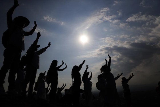 Visitors hold their hands out as they celebrate the Spring equinox atop the Pyramid of the Sun in Teotihuacan, Mexico, in 2019. (Marco Ugarte / The Associated Press files)