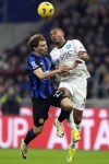 Inter Milan's Nicolo Barella jumps for the ball with Napoli's Juan Jesus, right, during the Serie A soccer match between Inter Milan and Napoli at the San Siro Stadium, in Milan, Italy, Sunday, March 17, 2024. (AP Photo/Antonio Calanni)