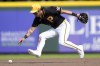 Pittsburgh Pirates second baseman Ji Hwan Bae fields a ground ball hit by Pittsburgh Pirates' Bryan Reynolds in the fifth inning of a spring training baseball game Tuesday, March 5, 2024, in Bradenton, Fla. (AP Photo/Charlie Neibergall)