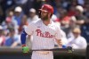 Philadelphia Phillies' Bryce Harper walks to the dugout after striking out in the sixth inning of a spring training baseball game against the New York Yankees Monday, March 11, 2024, in Clearwater, Fla. (AP Photo/Charlie Neibergall)