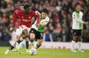 Manchester United's Kobbie Mainoo, left, is challenged by Liverpool's Wataru Endo during the FA Cup quarterfinal soccer match between Manchester United and Liverpool at the Old Trafford stadium in Manchester, England, Sunday, March 17, 2024. (AP Photo/Dave Thompson)