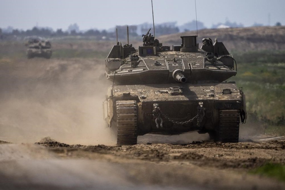 Israeli soldiers drive a tank on the border with Gaza Strip, in southern Israel, Tuesday, March 19, 2024. The army is battling Palestinian militants across Gaza in the war ignited by Hamas' Oct. 7 attack into Israel. (AP Photo/Ariel Schalit)