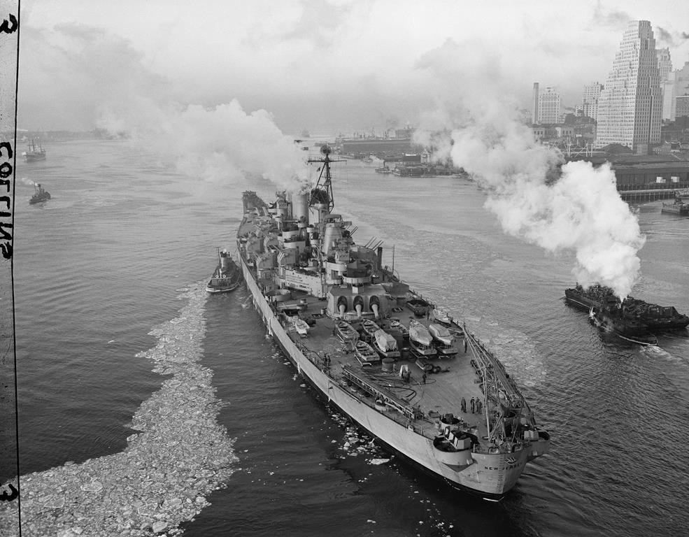FILE - The 52,000-ton Battleship USS New Jersey passes under the Brooklyn Bridge in New York, Jan. 31, 1948, enroute to Gravesend Bay to unload her ammunition and then back to the Brooklyn Navy yard for stripping. The mighty vessel, one of the heaviest armed ships in the world, will eventually be berthed at Bayonne, N.J., on a deactivated basis. The USS New Jersey is scheduled to move from its dock in Camden on Thursday, March 21, 2024, when it will head to the Philadelphia Navy Yard for extensive maintenance work. (AP Photo/Joe Caneva, File)