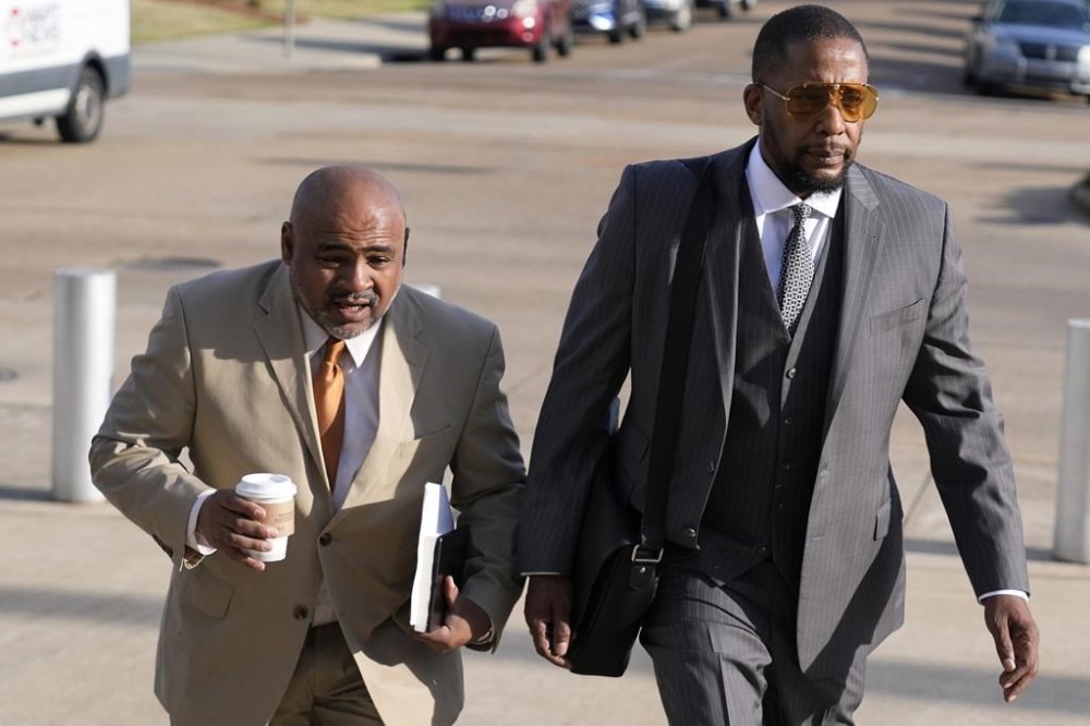 Civil co-counsels Trent Walker, left, and Malik Shabazz, for Michael Corey Jenkins and Eddie Terrell Parker, walk towards the Thad Cochran United States Courthouse in Jackson, Miss., Wednesday, March 20, 2024, for sentencing on the third of the six former Mississippi Rankin County law enforcement officers who committed numerous acts of racially motivated, violent torture on Jenkins and Parker in 2023. The six former law officers pleaded guilty to a number of federal charges for torturing them and sentencing began Tuesday in federal court. (AP Photo/Rogelio V. Solis)