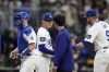Los Angeles Dodgers starting pitcher Yoshinobu Yamamoto, second from left, speaks with interpreter Will Ireton, second from right, as catcher Will Smith, left, and second baseman Gavin Lux during the first inning of a baseball game at the Gocheok Sky Dome in Seoul, South Korea Thursday, March 21, 2024, in Seoul, South Korea. (AP Photo/Lee Jin-man)