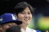 Los Angeles Dodgers designated hitter Shohei Ohtani, right, talks with starting pitcher Yoshinobu Yamamoto during the fourth inning of a baseball game against the San Diego Padres at the Gocheok Sky Dome in Seoul, South Korea Thursday, March 21, 2024, in Seoul, South Korea. (AP Photo/Lee Jin-man)