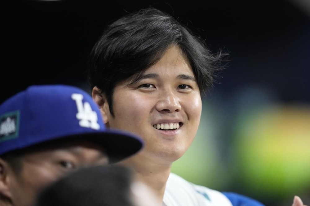 Los Angeles Dodgers designated hitter Shohei Ohtani, right, talks with starting pitcher Yoshinobu Yamamoto during the fourth inning of a baseball game against the San Diego Padres at the Gocheok Sky Dome in Seoul, South Korea Thursday, March 21, 2024, in Seoul, South Korea. (AP Photo/Lee Jin-man)