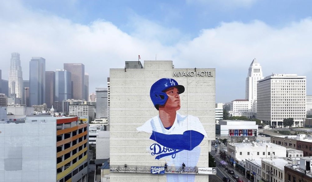 Muralist Robert Vargas, center, works on a new Los Angeles Dodgers baseball player Shohei Ohtani mural titled