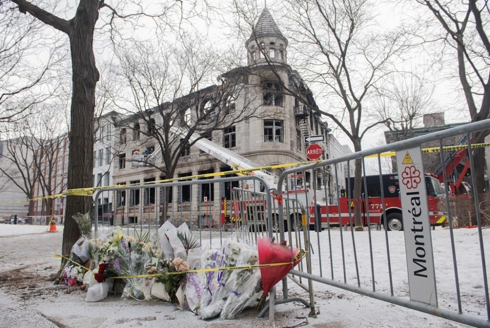 A makeshift memorial is shown at the scene following a fire in Old Montreal, Sunday, March 19, 2023, that gutted a heritage building. A Quebec man who spent 51-months on the lam from a federal prison before being arrested last year has pleaded guilty to escaping custody. THE CANADIAN PRESS/Graham Hughes