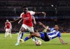Arsenal's Bukayo Saka, left, and Porto's Galeno battle for the ball during the Champions League round of 16, second leg soccer match between Arsenal and Porto at the Emirates Stadium, London, Tuesday March 12, 2024. (Zac Goodwin/PA via AP)