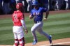 Texas Rangers' Wyatt Langford scores on a sacrifice fly by Travis Jankowski during the third inning of a spring training baseball game as Los Angeles Angels catcher Logan O'Hoppe looks on, Monday, March 11, 2024, in Tempe, Ariz. (AP Photo/Matt York)