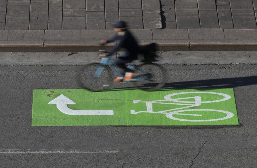 A cyclist makes their way along a roadway in a lane marked for bicycles, Wednesday, Nov. 2, 2022 in Ottawa. Bodies and minds are just as affected by climate change as sea ice and forests, says University of Alberta scientist Sherilee Harper. THE CANADIAN PRESS/Adrian Wyld