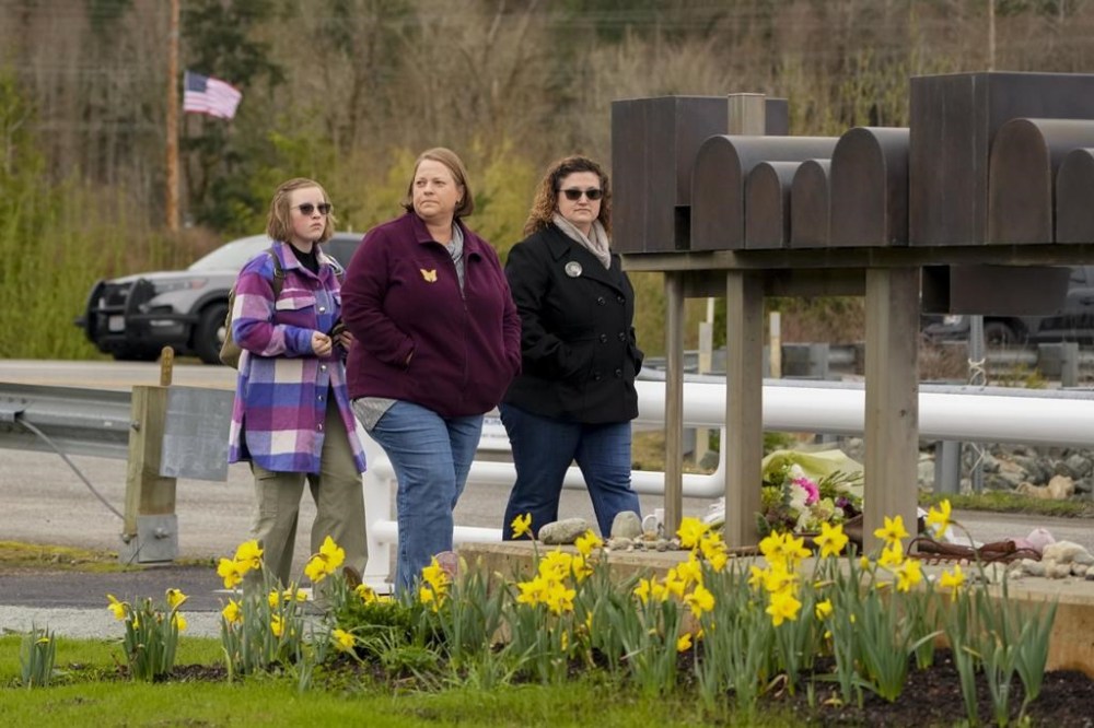 People walk by a mailbox art installation while arriving for the Oso Landslide Memorial dedication on the 10-year anniversary of the disaster, Friday, March 22, 2024, in Oso, Wash. The landslide that killed 43 people and wiped out a neighborhood is the deadliest in United States history. (AP Photo/Lindsey Wasson)