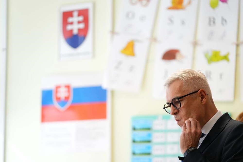 Presidential candidate Ivan Korcok prepares to cast his vote during the first round of the presidential election, in Senec, Slovakia, Saturday, March 23, 2024. (AP Photo/Petr David Josek)