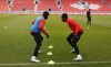 Jonathan David (left) and Alphonso Davies take part in a drill Monday, March 27, 2023 at Canada’s training session at BMO Field in Toronto. Canada, ranked 50th in the world, takes on No. 96 Trinidad and Tobago with a berth on this summer's Copa America on the line. &nbsp;THE CANADIAN PRESS/Neil Davidson